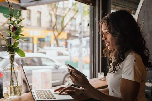 business owner checking closure date and certificate PDF on laptop
