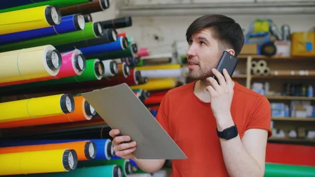 business owner checking discount coupon on phone