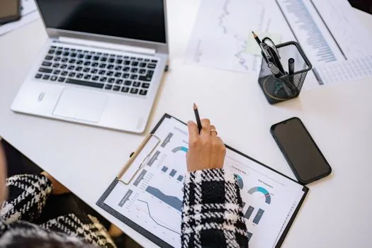 business owner reviewing employment insurance online report result on laptop with checklist, bright realistic office photo | 고용·산재보험 토탈서비스 신고 후 처리 결과를 확인하는 장면