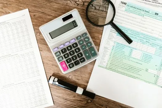 Korean tax filing desk with laptop calculator and business documents