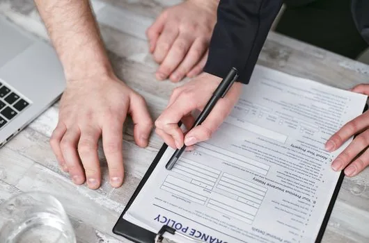 landlord and tenant signing rent reduction agreement in small office