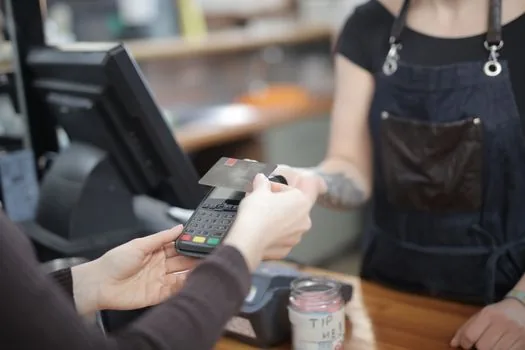 local currency payment at small shop counter