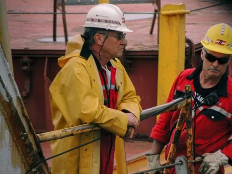 shipyard safety meeting with checklist helmets and work permit documents
