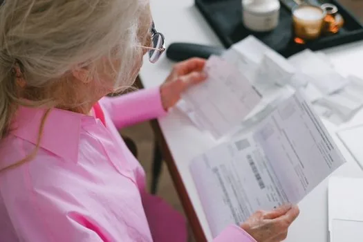small business owner checking loan documents and cash flow