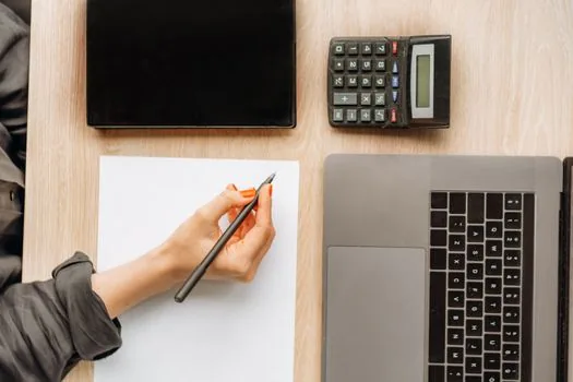 trademark application fee calculation with product class list, Korean startup desk, calculator and brand notes, realistic photo