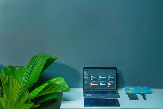 employee ID access log and calendar schedule compared on a laptop by HR manager, modern Korean office, realistic editorial business photo