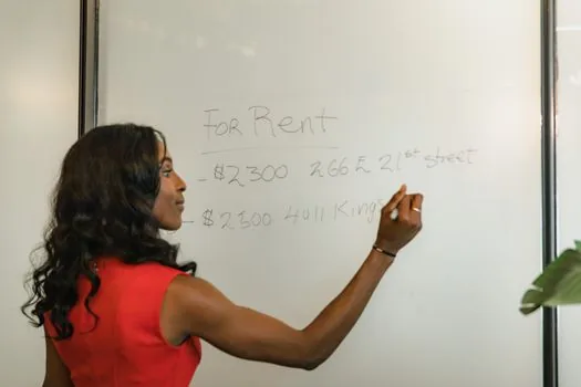 founder marking rented unit on building floor plan beside lease deposit and monthly rent calculation sheet