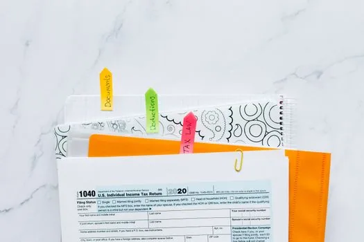 Korean business owner comparing payroll payment month, withholding tax calendar and Hometax report checklist, realistic bright office photo