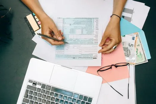 Korean business owner reviewing income certificate, tax payment certificate and VAT certificate checklist