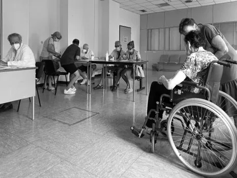 Korean nursing home office staff checking caregiver shift roster and lunch break coverage chart, realistic photo