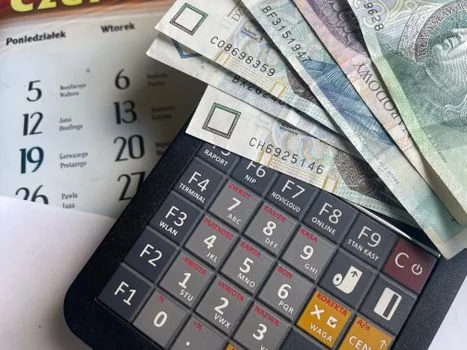 Korean office desk with cash flow spreadsheet, monthly loan repayment calendar, calculator, and separate personal and business account folders