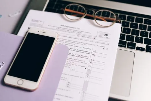 Korean office payroll calendar with parental leave application papers, small business HR checklist, bright realistic photo