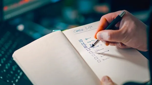 Korean payroll manager checking employee age and tax reduction checklist beside business registration certificate, realistic office photo | 직원 나이와 회사 요건을 함께 대조하는 급여 서류 점검 장면
