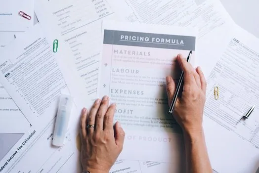 Korean small manufacturer reviewing parts quotation, labor cost sheet and delivery contract