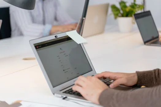 Korean sole proprietor comparing digital certificate options, business registration certificate, laptop login screen, and public procurement checklist on a bright office desk | 나라장터 등록 전 사업자 인증서 용도를 나눠 확인하는 장면