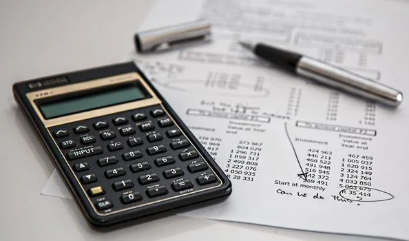 Korean tax notice and sales ledger on desk with calculator and July calendar | 과세유형 전환 통지와 매출 기준을 함께 확인하는 장면
