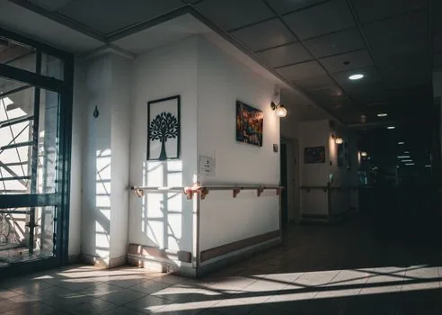 nursing facility hallway safety checklist with door lock window railing and balcony inspection items, realistic editorial photo