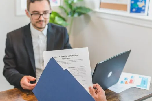 office desk with government certificate PDF filenames organized for loan application