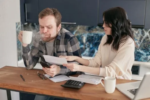 business owner comparing spreadsheet totals with Hometax card sales and cash receipt columns, coffee cup and tax calendar nearby, realistic Korean office photo | 홈택스 매출자료와 플랫폼 파일을 대조하는 장면