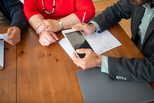 couple comparing personal debt list, business loan statement and monthly repayment schedule on tablet, realistic Korean finance office photo | 부부 부채와 사업자 대출 상환표를 따로 대조하는 장면
