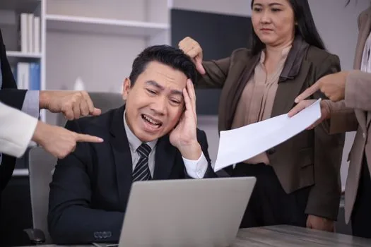 Korean business owner checking ten day deadline on calendar with employment paperwork and laptop, realistic editorial photo | 요청서 접수일을 기준으로 10일 기한을 확인하는 장면