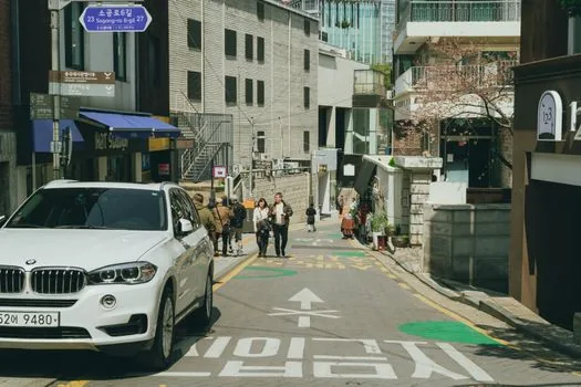 Korean cafe startup founder checking neighborhood commercial area map before lease signing