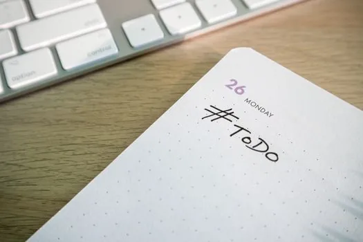 Korean employer checking furlough schedule, employee list, calendar and employment support checklist on office desk | 휴업 계획표와 대상 근로자 명단을 대조하는 장면