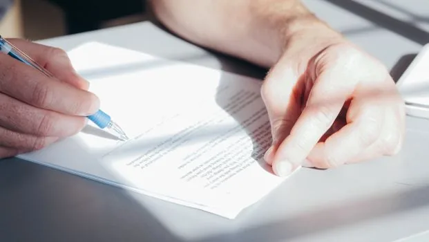 Korean employer checking retirement pension rule draft and employee consent memo on office desk, realistic business paperwork photo