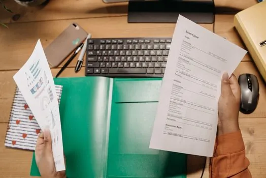 Korean entrepreneur comparing personal mortgage budget and business loan documents