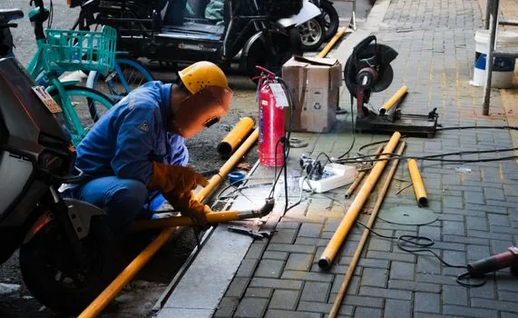 Korean store owner checking fire extinguisher tag, evacuation map and fire safety appointment checklist