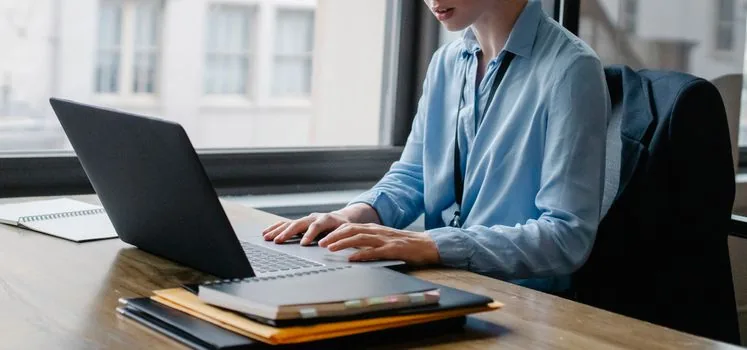 laptop showing labor portal application status with retirement pension rule file checklist, realistic Korean office desk