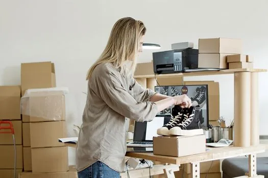 online store footer business information being updated with mail order sales report number, laptop and checklist, realistic office photo | 신고증 번호를 쇼핑몰 사업자 정보에 입력하는 장면