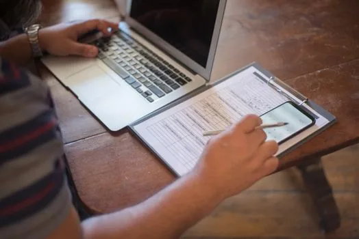 restaurant owner checking floor area document and business insurance checklist on a bright desk, realistic Korean small business scene, no logos | 1층 음식점 면적과 영업신고 정보를 대조하는 장면