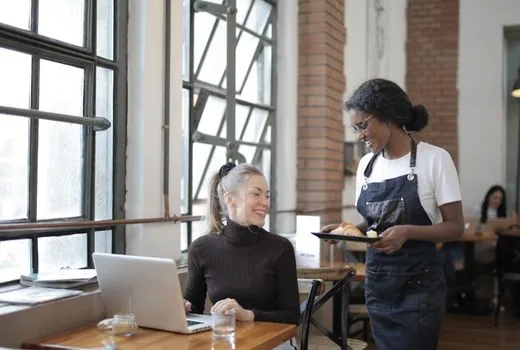 small business owner comparing cafe, restaurant, and retail category data on a laptop