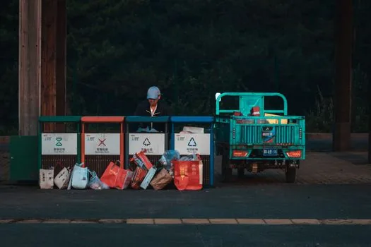 Small business owner comparing waste disposal consignment contract, processor license copy and collection schedule | 폐기물 위수탁계약서와 처리업체 서류를 대조하는 장면