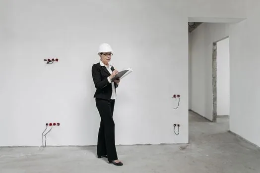 Workplace manager reviewing rest facility checklist for lighting ventilation temperature and seating