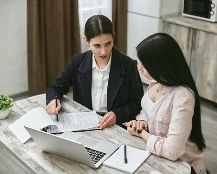 HR manager comparing employment contract employee roster and address change memo on laptop desk | 근로계약서와 근로자명부의 주소·업무·계약기간을 대조하는 장면