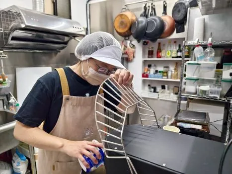 Korean restaurant owner comparing business license application, hygiene training certificate checklist and calendar on a clean kitchen counter | 음식점 창업 전 위생교육과 영업신고 서류를 대조하는 장면