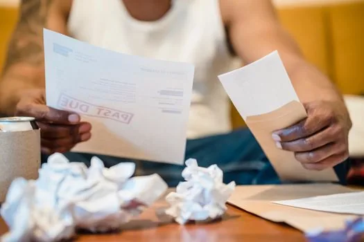 small business representative comparing home tax receipt and local tax payment receipt on desk, realistic photo, no logo